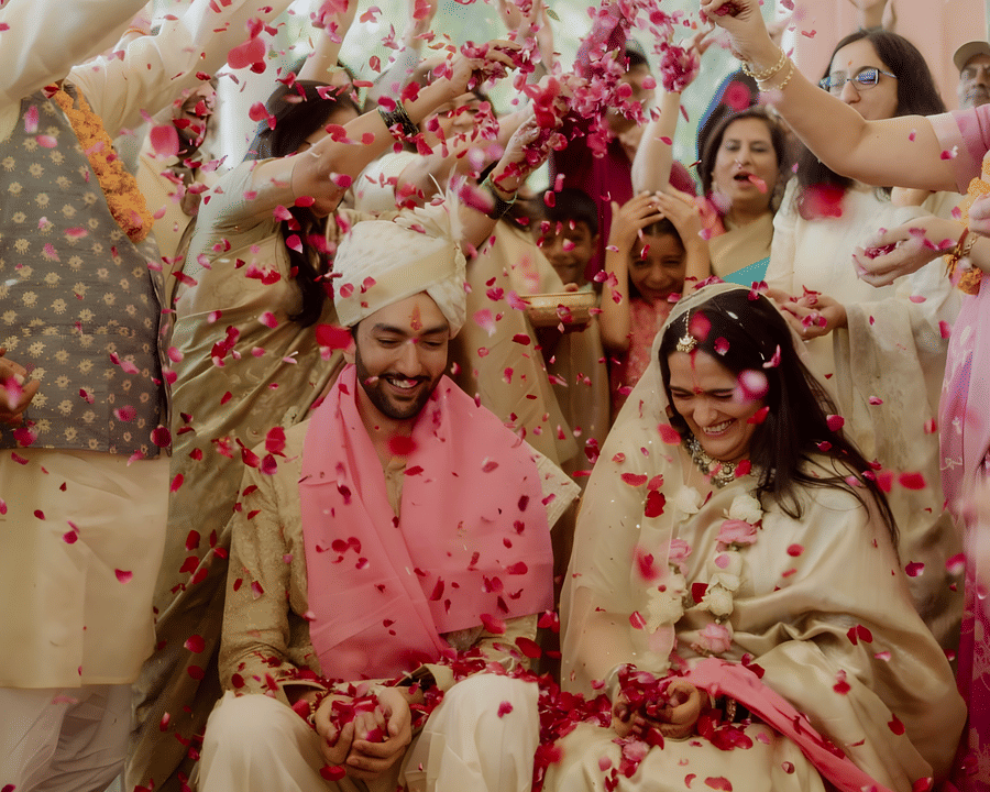 Guests celebrating with flowers during wedding function of Charvi & Dhruv at Umaid Palace.