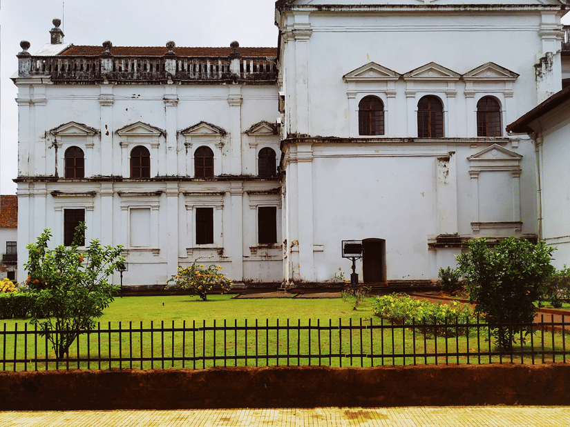 Se Cathedral in Old Goa, one of the must-visit attractions in South Goa, surrounded by manicured lawn and metal railing