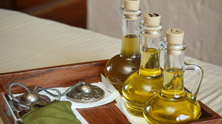 A tray kept on a spa bed which has massage oil and other massage equipment at Kavya Himalayas, Nagarkot.