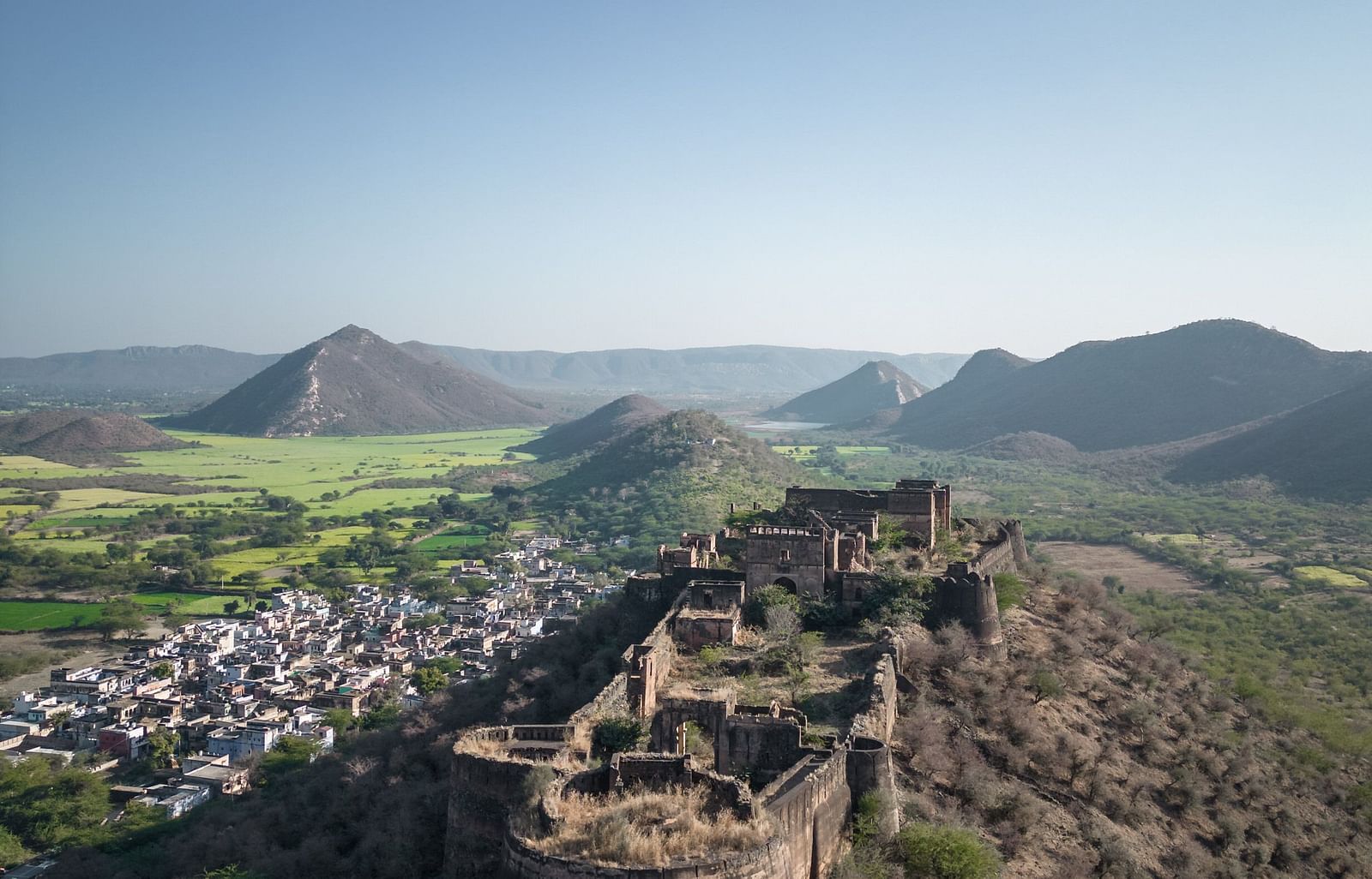 An aerial image of a fort with the backdrop of mountains