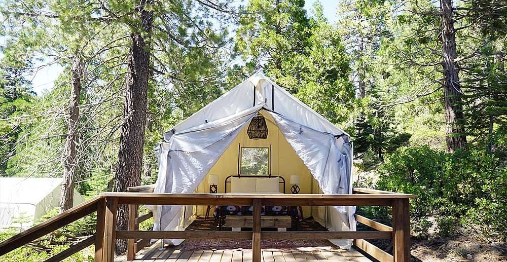 Exterior of a tent surrounded by trees at Shaver Lake Village Hotel.