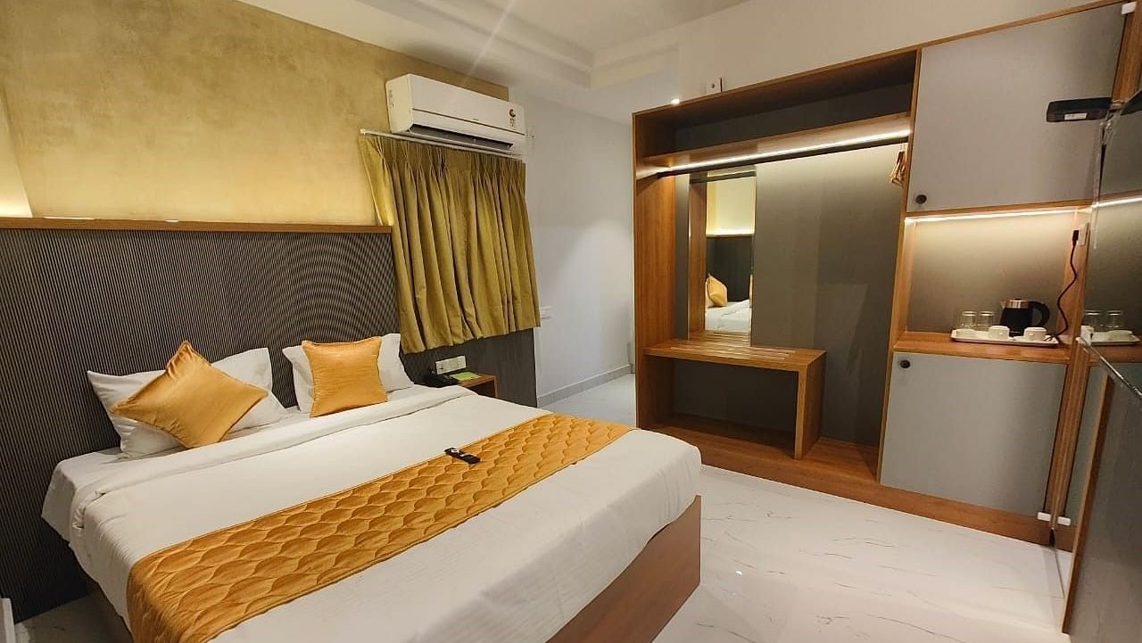a view of the king sized bed of room at hotel La Premier 