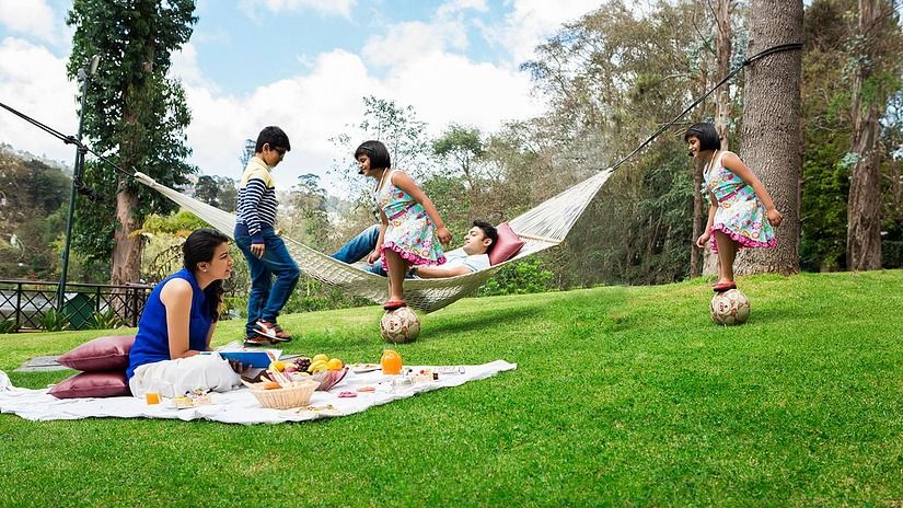 a family playing on a hammock