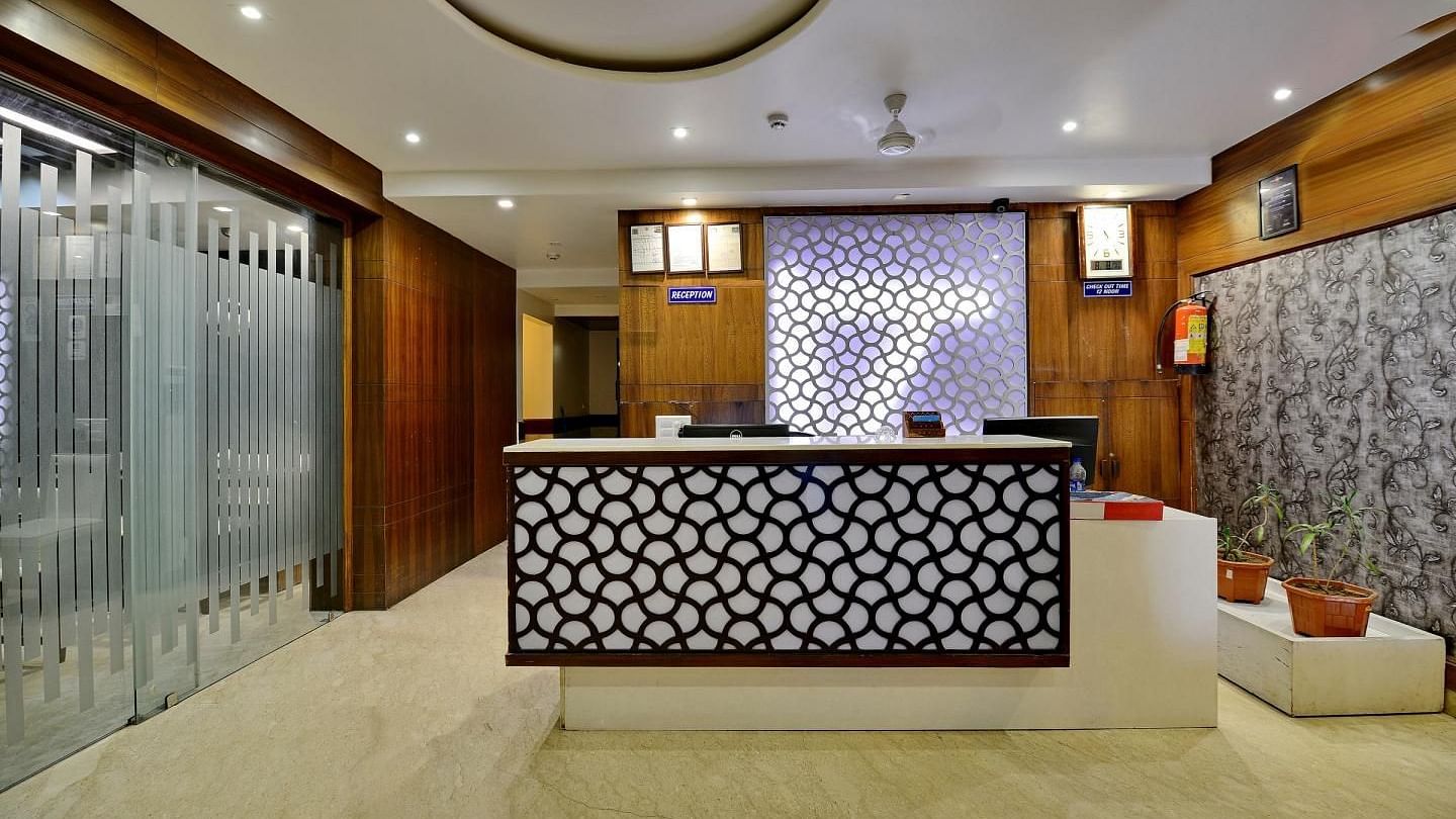 A modern hotel reception area with a stylish counter and warm lighting - Hotel Emerald, Chandigarh