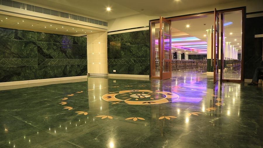 Side view of entrance DS Mahal Hall at Dhanalakshmi Srinivasan Hotels, Perambalur with a door and purple ceiling light.