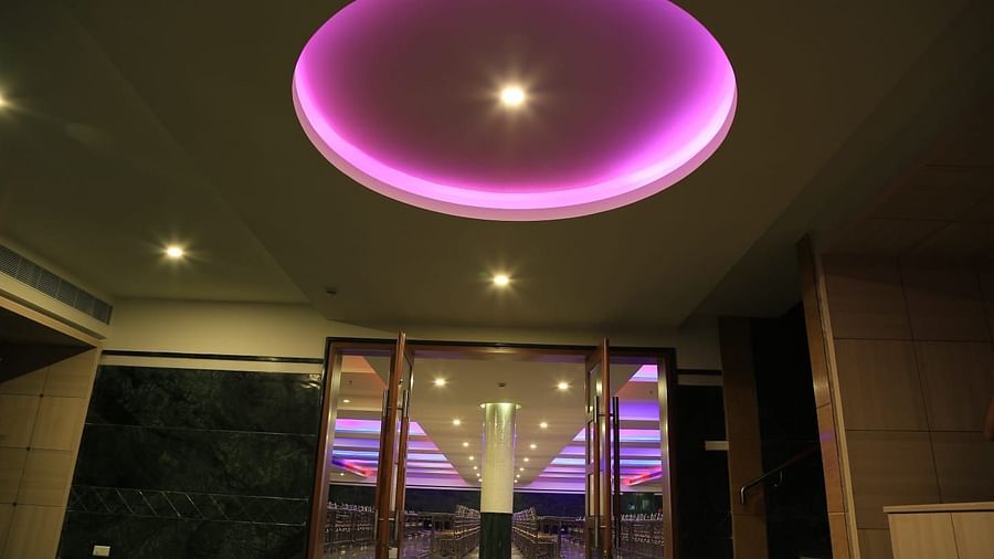 Overview of entrance DS Mahal Hall at Dhanalakshmi Srinivasan Hotels, Perambalur with a door and purple ceiling light.