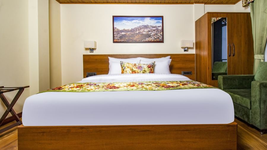 Suite With Balcony room with a cosy bed and wardrobe in the corner at Mount Lungta Boutique Hotel & Spa