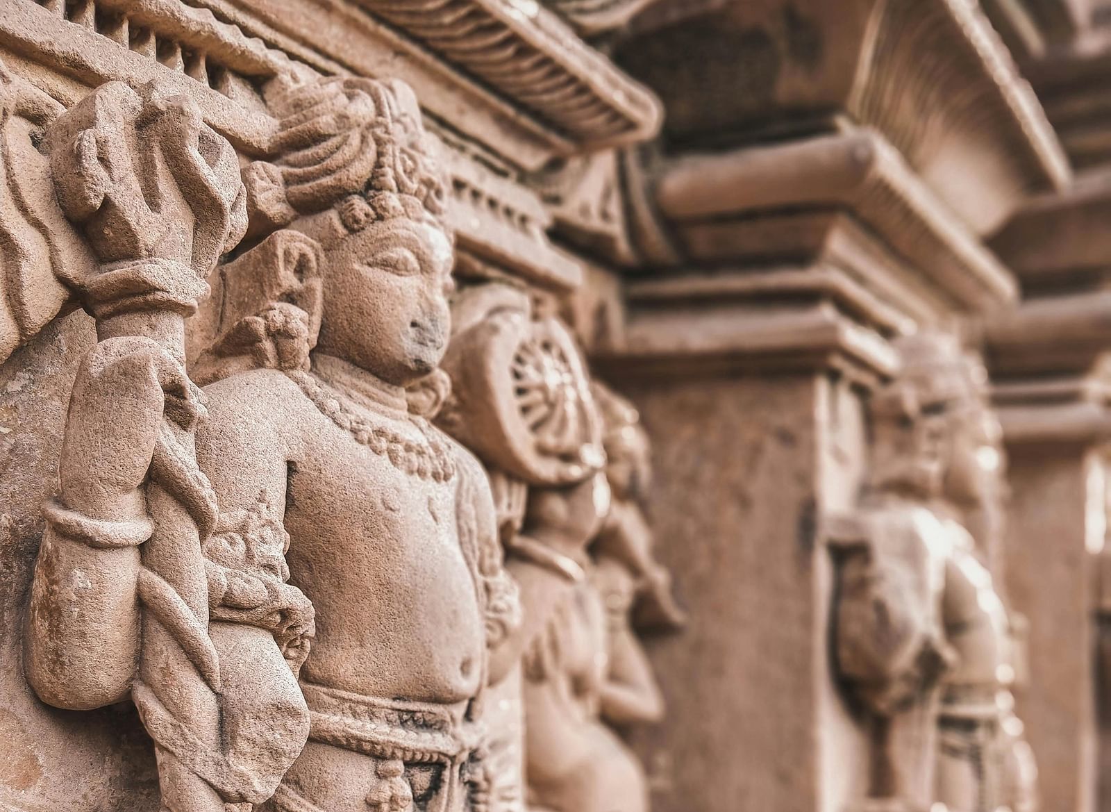 Close-up of intricate stone carvings depicting warriors, showcasing the detailed artwork and historical significance.