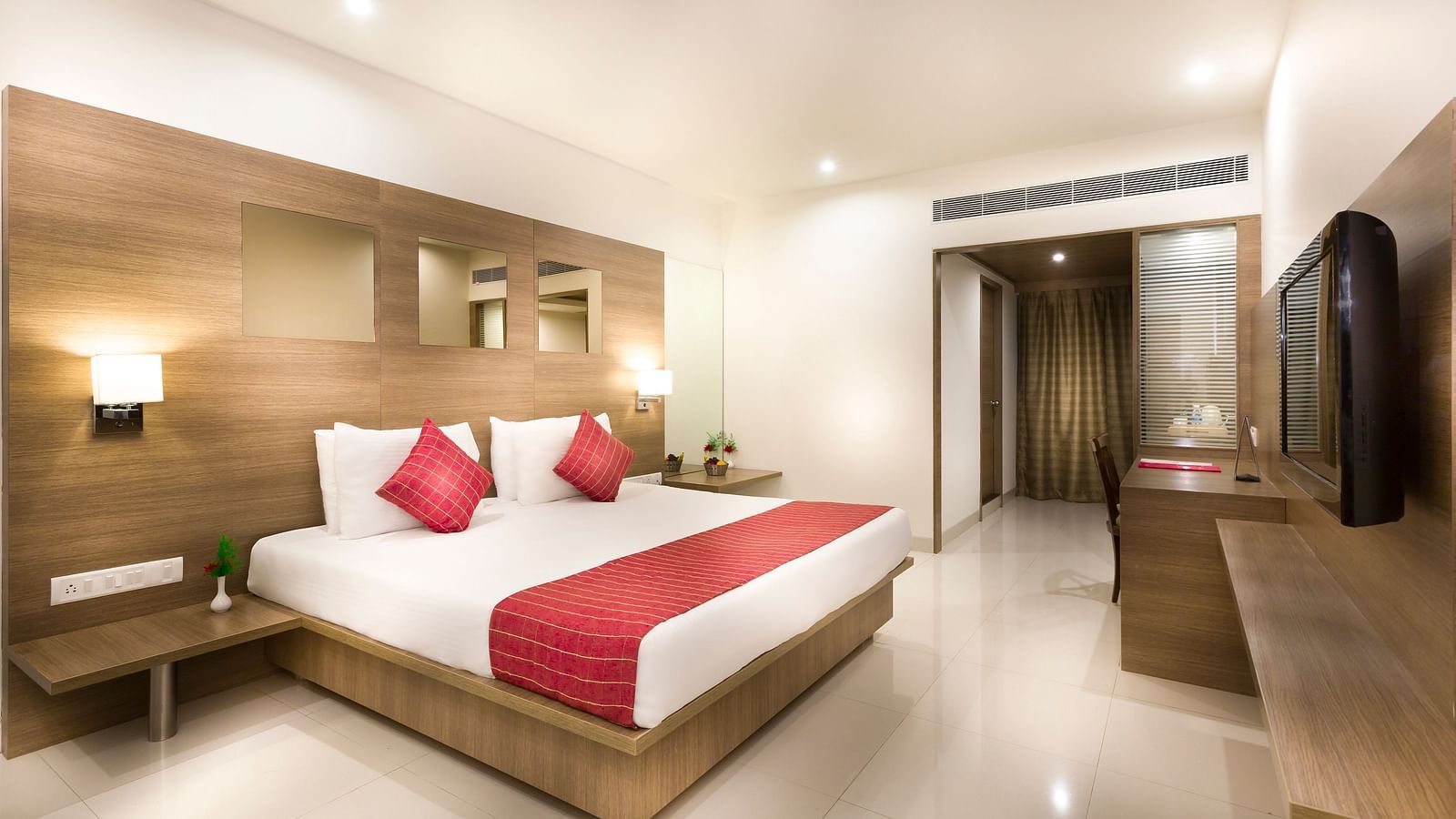An image of a king size bed of a Deluxe Room at Regency Tiruttani by GRT Hotels.