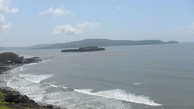 A scenic view of the Murud beach with greenery on one side of the coast