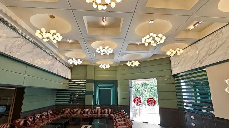 The boardroom at Hotel Gold, Panipat featuring a several beautiful chandeliers hanging from the ceiling.