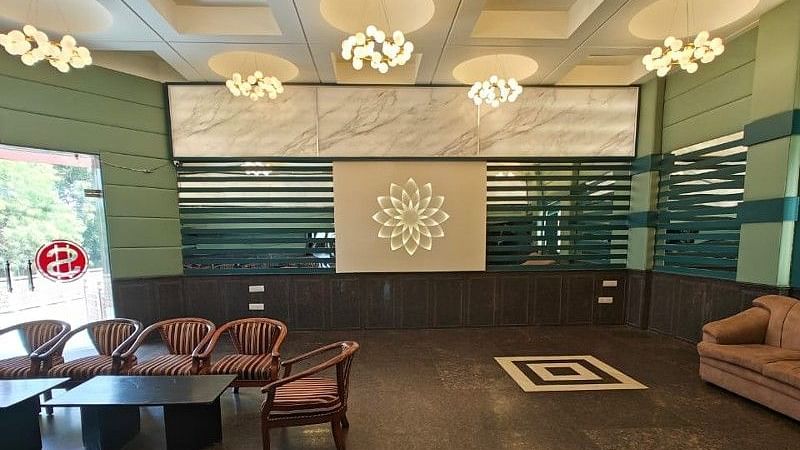 The boardroom at Hotel Gold Panipat with huge entrance door made of glass in the corner.
