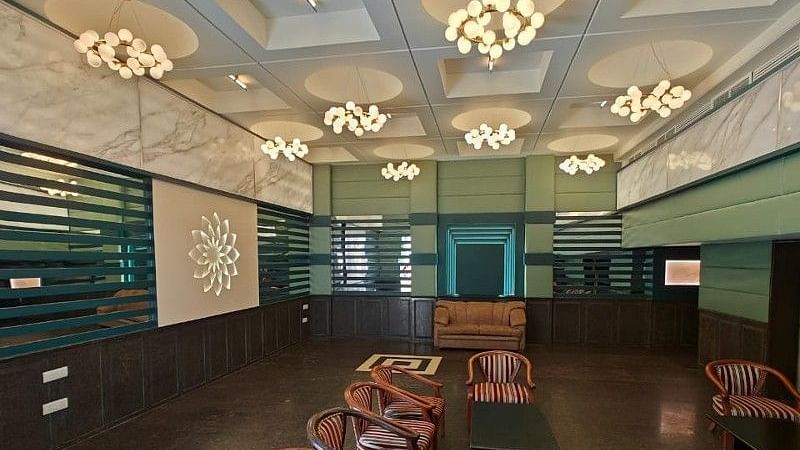 Full view shot of the Boardroom at Hotel Gold, Panipat with several brown coloured leather arm chairs arranged facing towards each other.