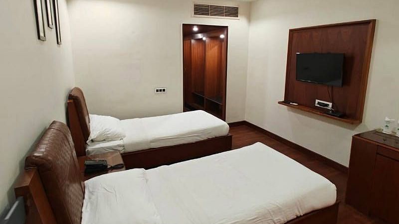 The Luxury Room from a higher angle featuring a wall mounted television in front of it - Hotel Gold, Panipat