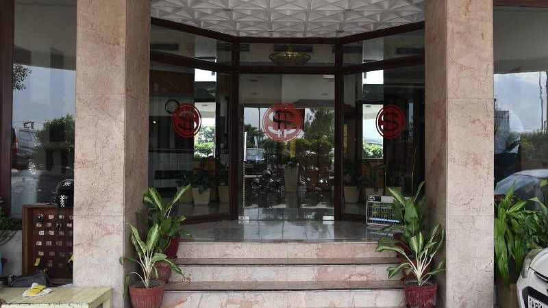 Several steps lined up with potted plants leading to the entrance of Hotel Gold, Panipat.