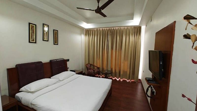 Full view shot of the bedroom of the Suite with golden coloured curtains blocking the natural sunlight - Hotel Gold, Panipat