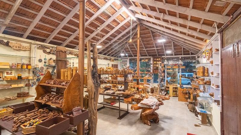 Image of an indoor space with wooden artifacts at Parampara Resort & Spa, Kushalnagar.