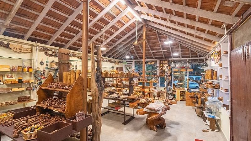 An indoor space with wooden artifacts at Parampara Resort & Spa, Kushalnagar.