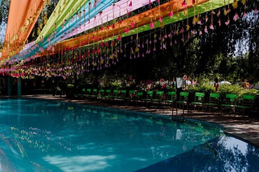 A poolside wedding venue with colourful decorations at a Heritage Resort in Jaipur - Umaid Palace - A Lakeside Heritage Palace Resort
