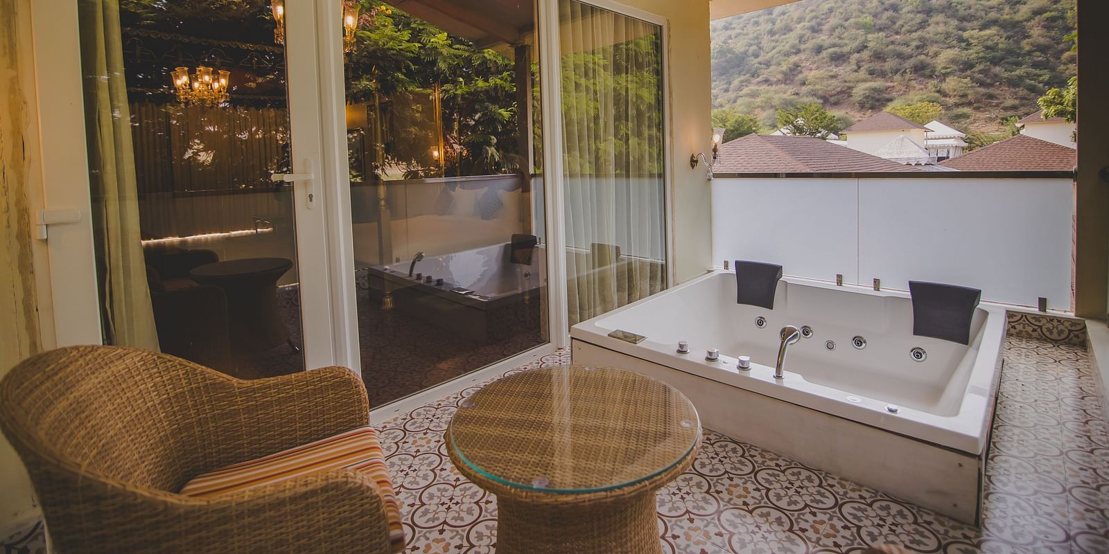 Image of a Jacuzzi with flower petals and a chair on the side at Rajasthali Resort & Spa Jaipur.