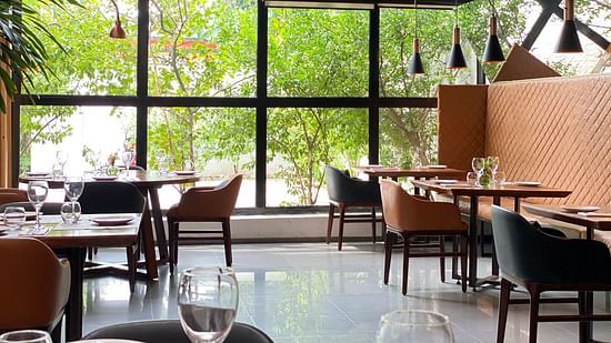 View of dining area with several tables and chair, all designed in contemporary style - Mastiff Grand- The Sia Palace Suites and Banquets, Khopoli
