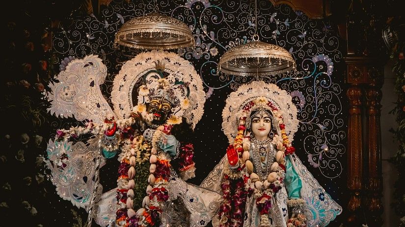 two garlanded idols in a temple