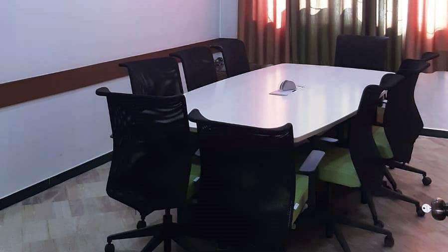 Air conditioned Board room with table and office chairs at Hotel Dr Rajkumar International.
