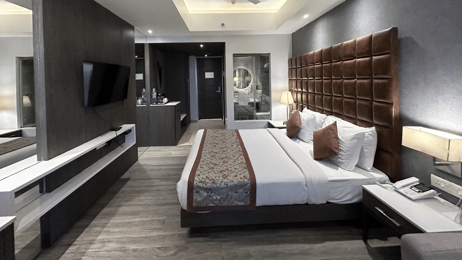 An interior view of a bedroom looking towards the entrance, featuring a double bed and a ceiling fan | Sand Heaven