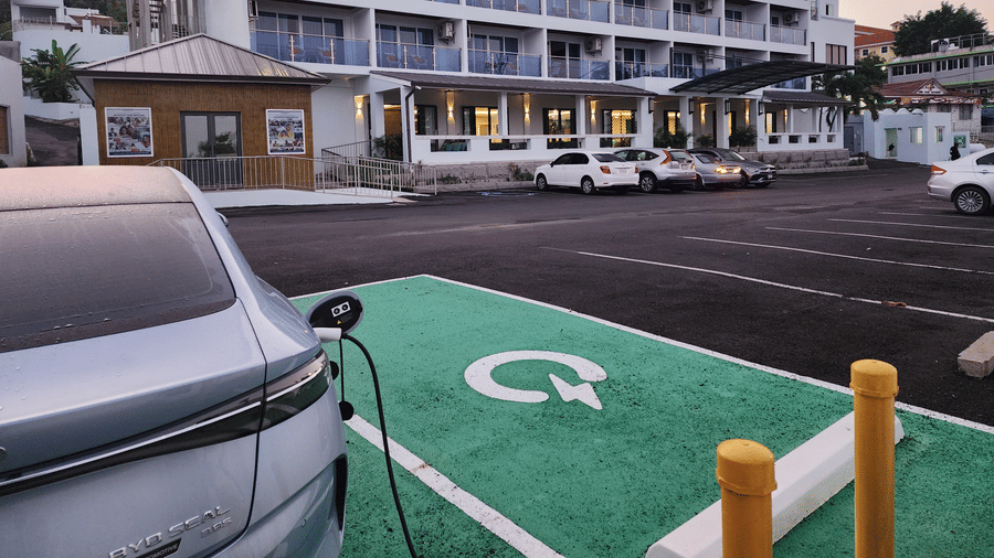 A hotel exterior with an electric car charging station in the parking lot - Hotel 39, Jamaica - Family Vacations in Jamaica