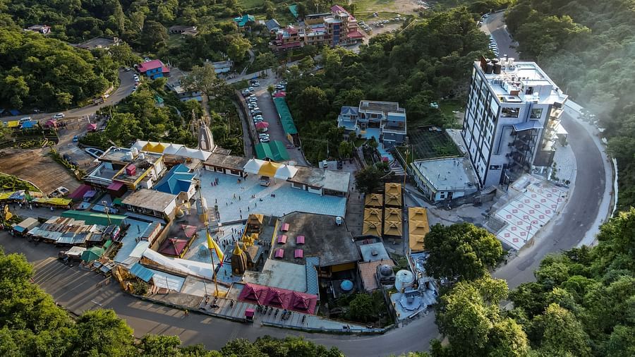 An aerial shot of a hotel building in Kangra by the side of Mata Baglamukhi Temple - NAMAMI BY ZENQ BANKHANDI
