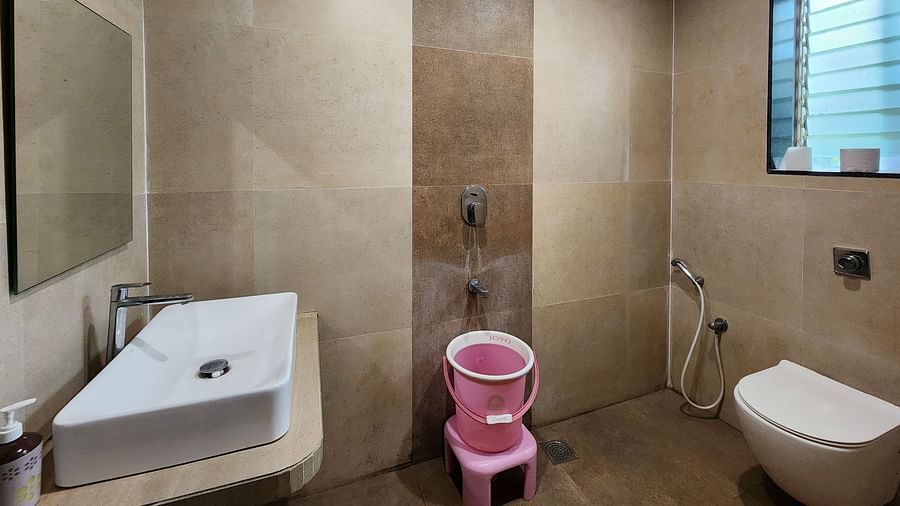Bathroom of Premium Room at The Kanila Resort featuring a toilet, sink area and a bucket.