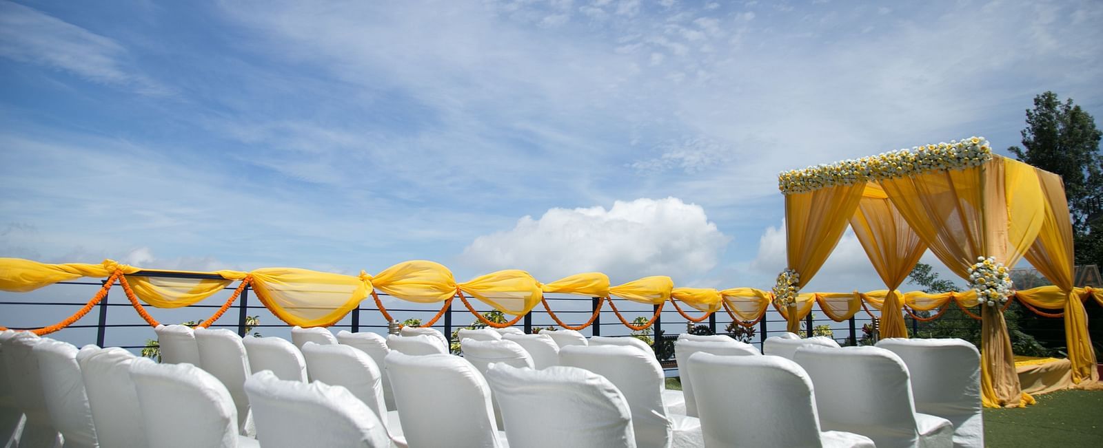 An image of the open banquet space with chairs and decoration - Great Trails Yercaud by GRT Hotels