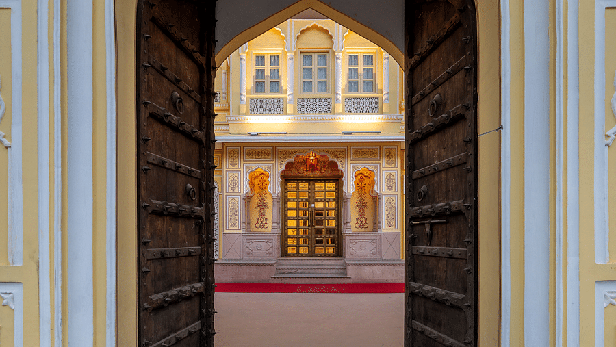 the entrance door frame to our hotel leading to the courtyard with heavy open wooden doors - Brij Castle, Jaipur