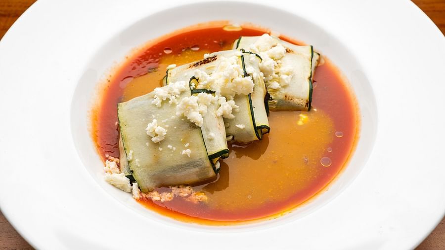 An image of a dish elegantly floating in a plate of sauce - S Hotel Montego Bay, Jamaica
