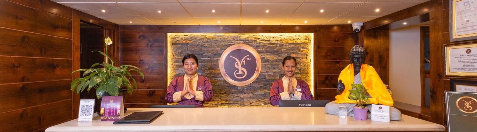 Front desk with warm lighting and décor at Sumitel Premier Inn, Siliguri.