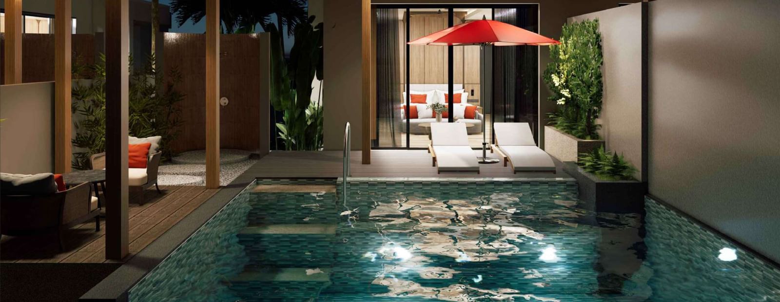 A nighttime view of the private pool villa at Ramada Resort by Wyndham Khao Lak, with the pool lit up and stars in the sky.