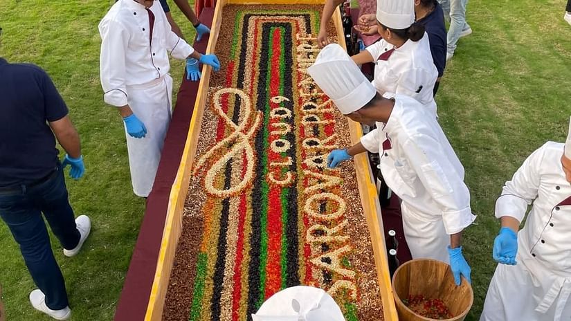 An image of chefs decorating cake with dry fruits at Cloud9 Sarovar Premiere, Palolem Goa