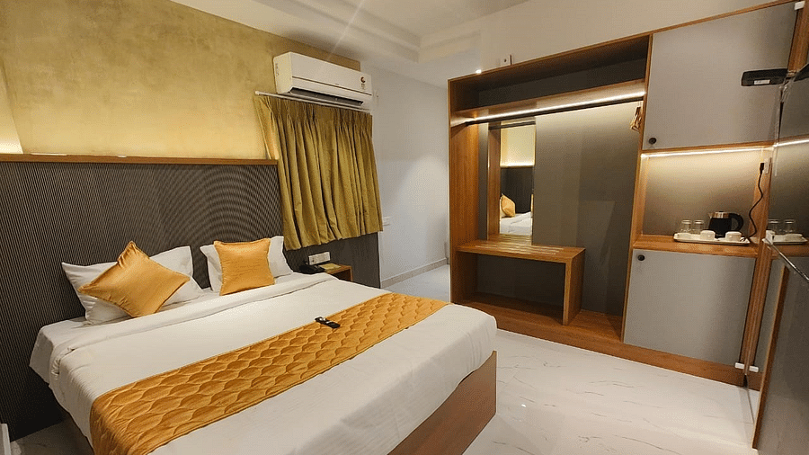a view of the king sized bed of room at hotel La Premier 