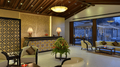 Lobby at Golden Tulip, Srinagar featuring a reception desk and chairs and sofas organised