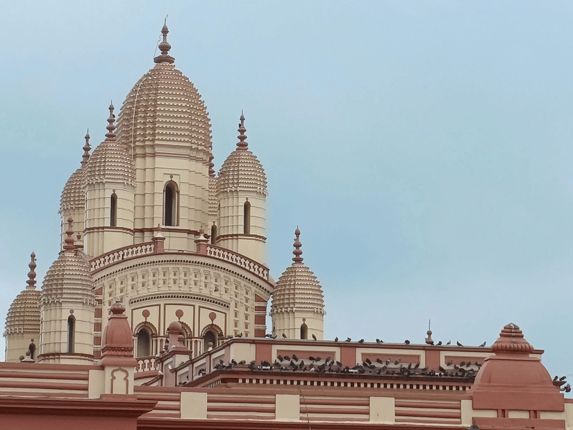A close up view of the Dakshineshwar Kali temple with its traditional architecture under blue sky.
