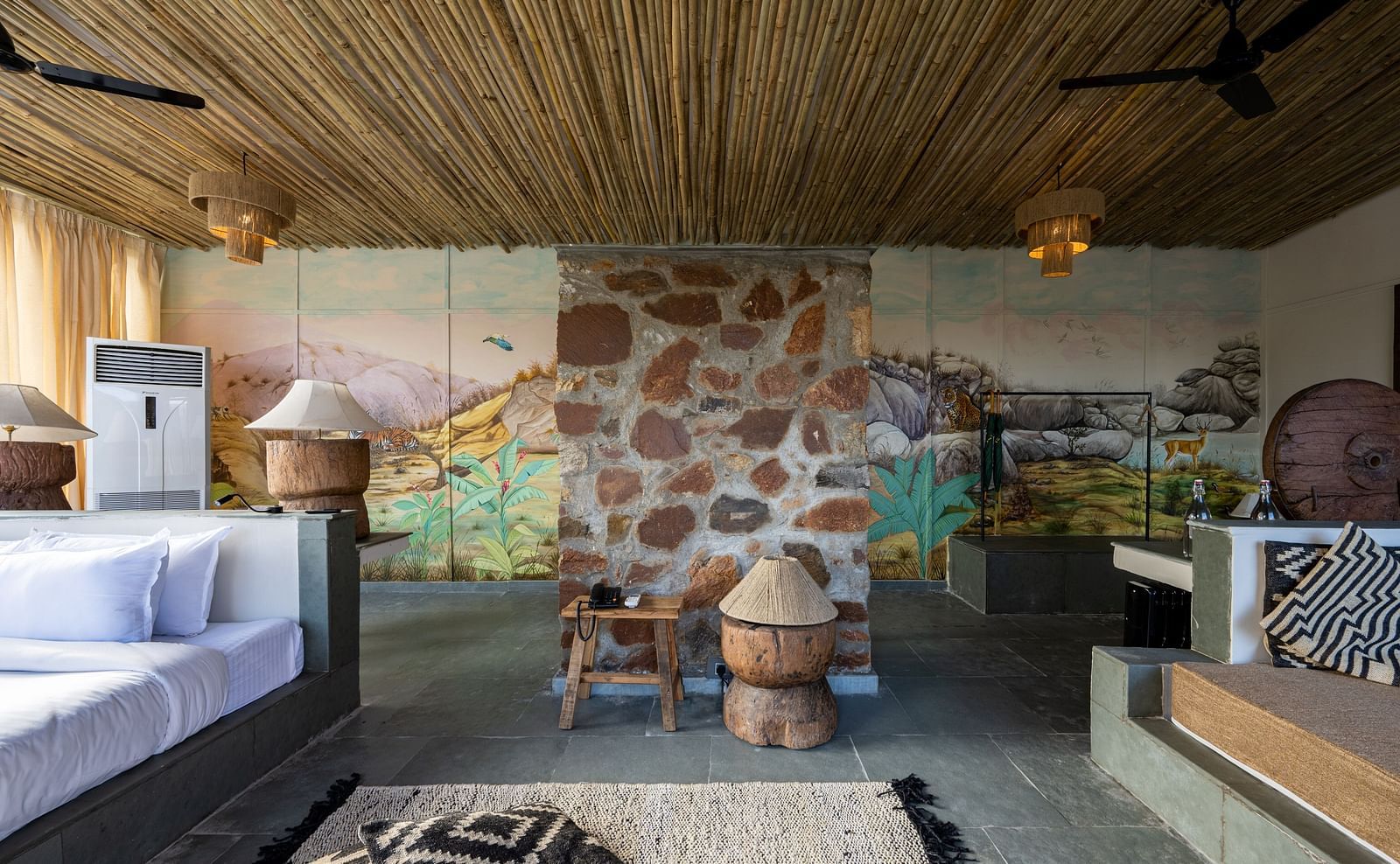 A view of our room with a bed on the left and sofas on the right - Utsav Camp