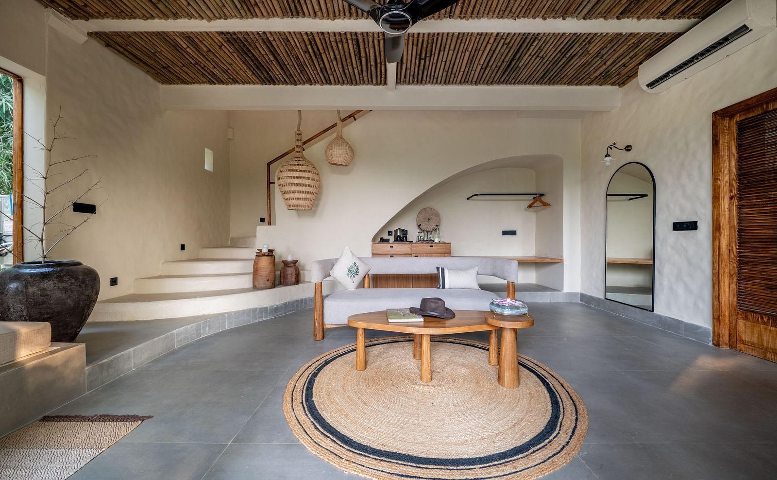 Interior view of a stylishly furnished living area with a circular table in the center.