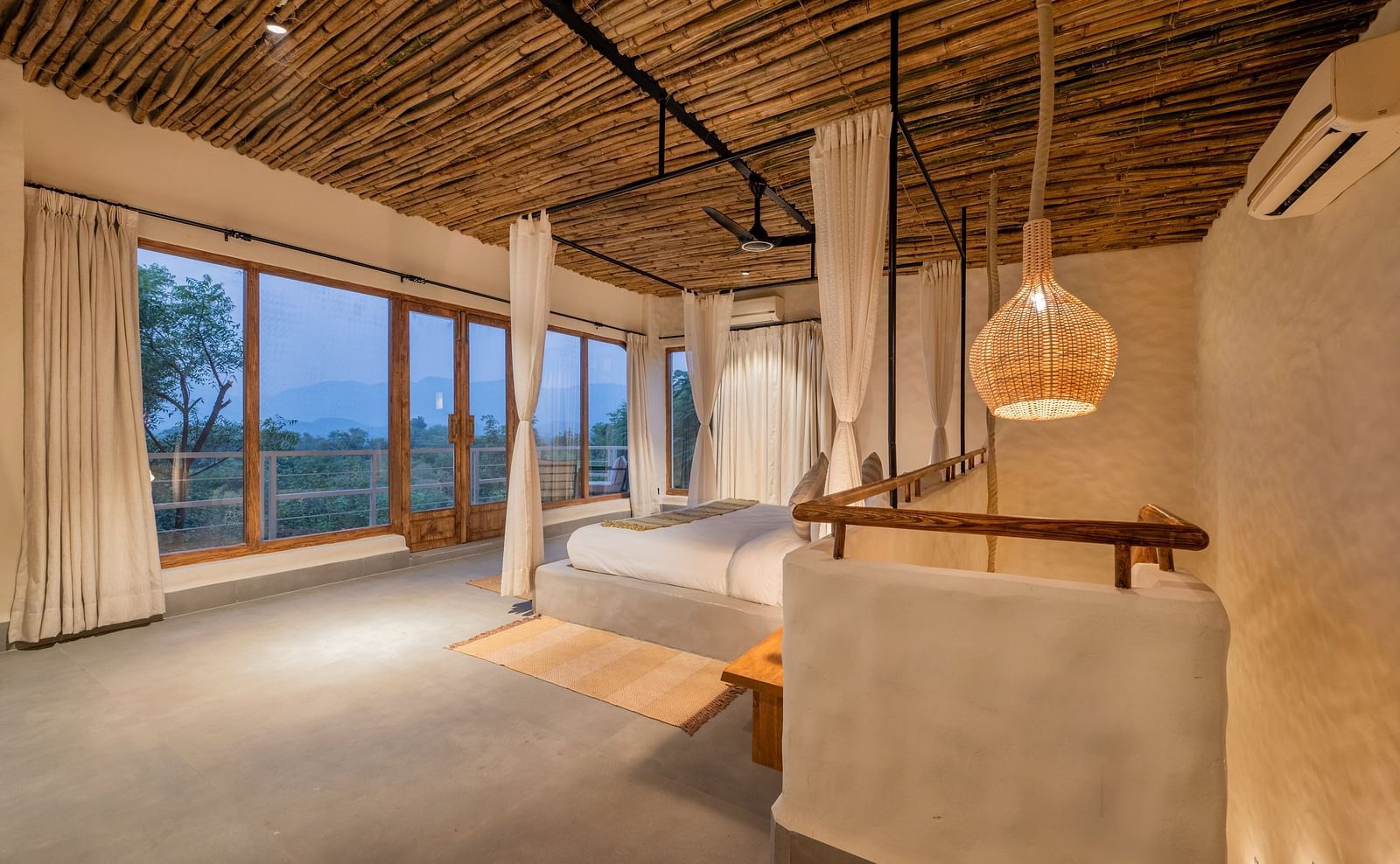 bedroom with large windows, natural wood accents, and minimalistic decor.