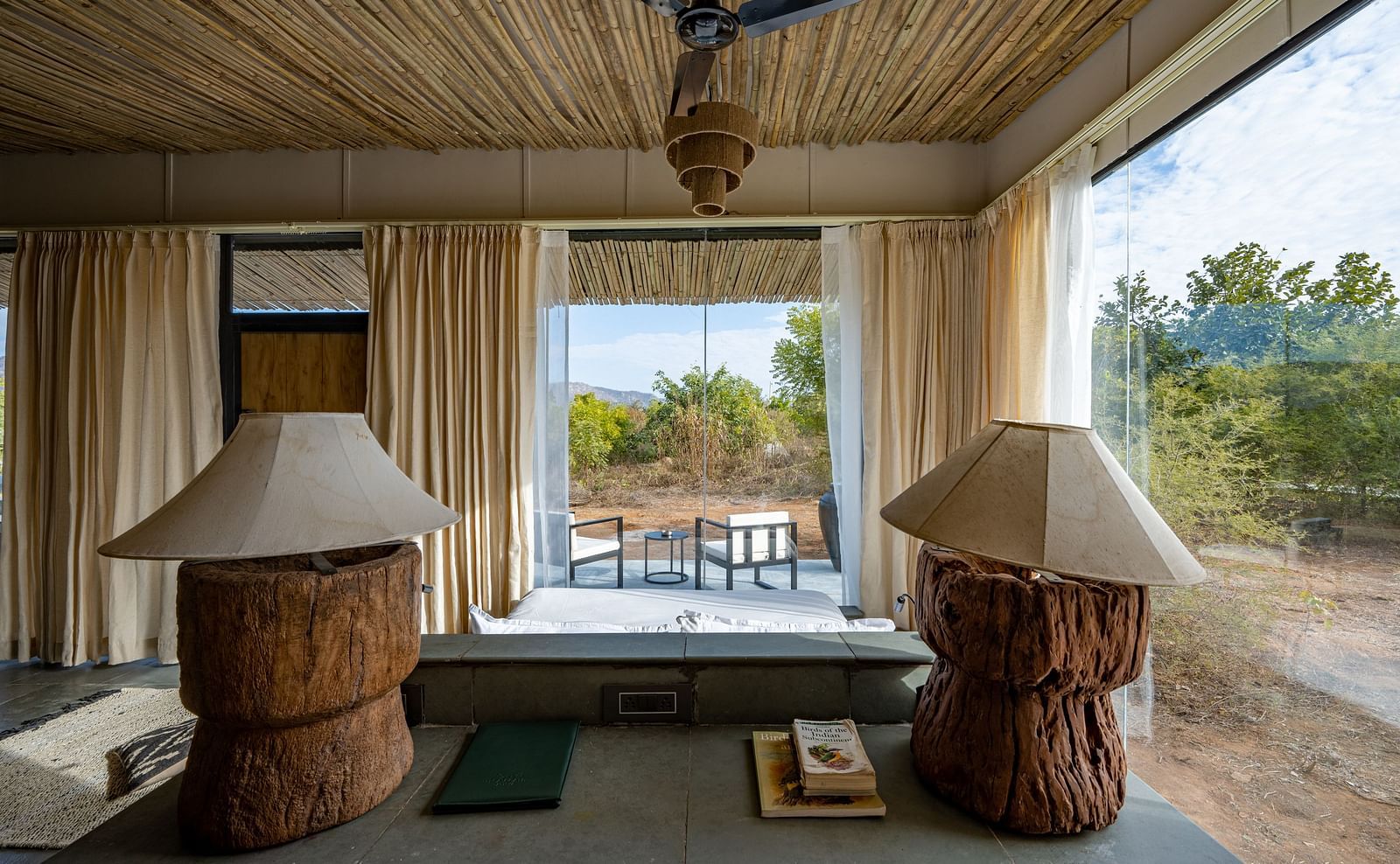 An image of a room with decorative lamps, chandelier, a ceiling fan - Utsav Camp Sariska