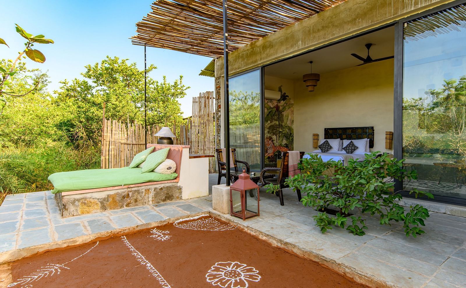 An image of a room with outdoor seating amidst lush greenery - Utsav Camp Sariska