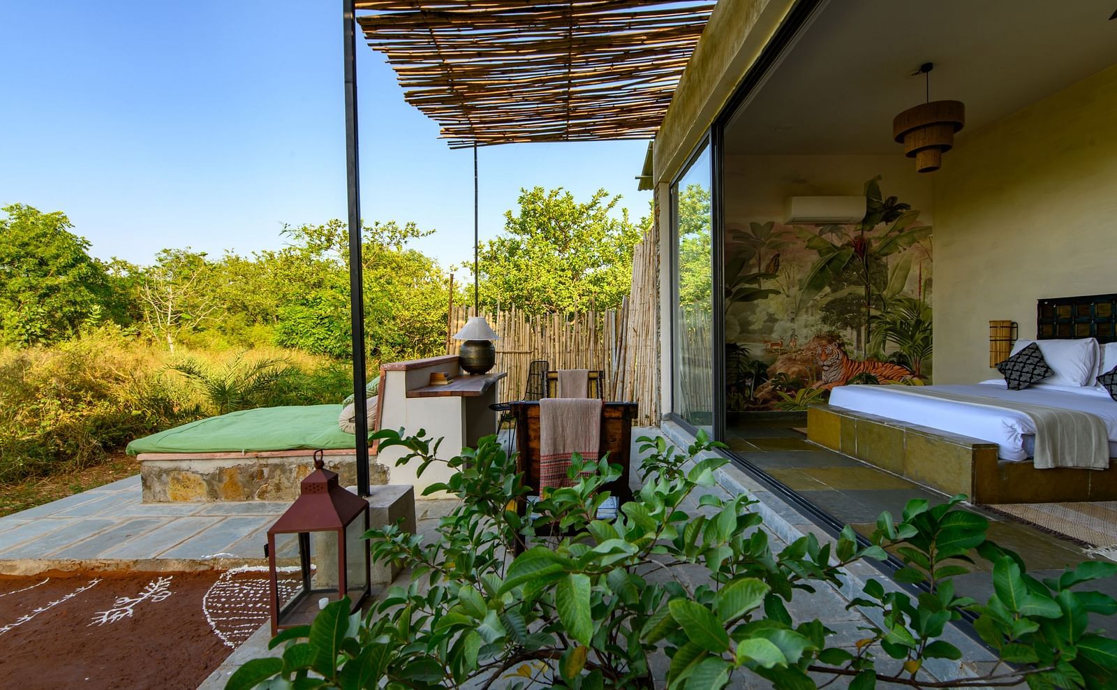 An image of a room with outdoor seating amidst lush greenery - Utsav Camp Sariska
