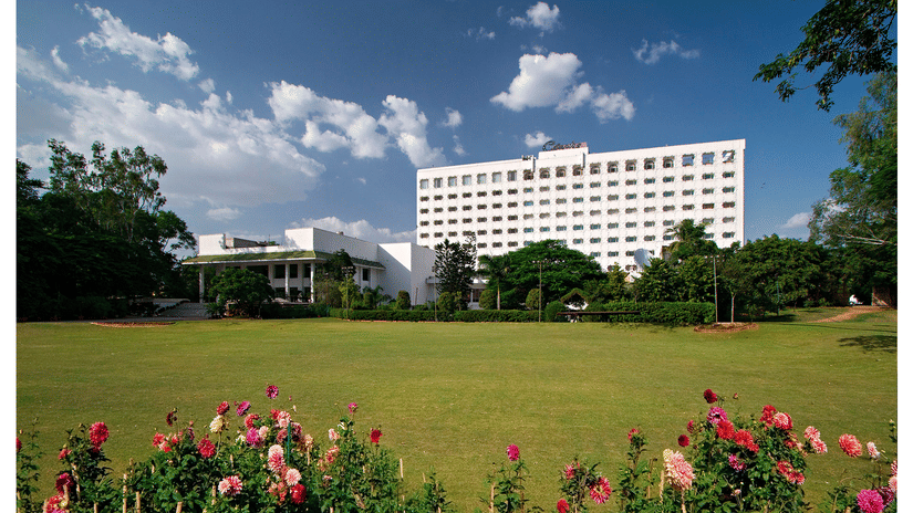 A panorama of the facade and the green lawn in the foreground at Hotel Clarks Amer, the best hotel in Jaipur near the airport.