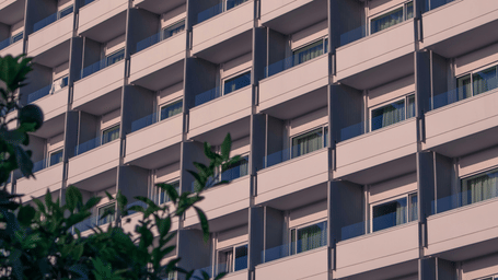 A repetitive architectural view of several identical balconies.