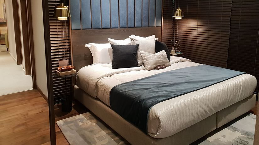 A double bed with lamps and side table on either side of it