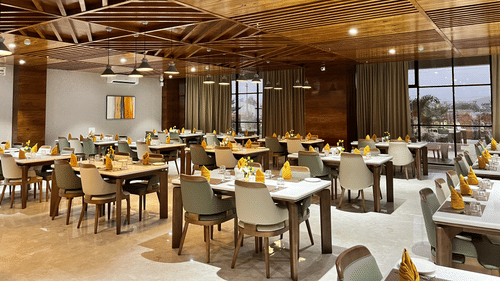 interior of a restaurant at VITS Satyajeet Karad featuring elegant seating arrangement